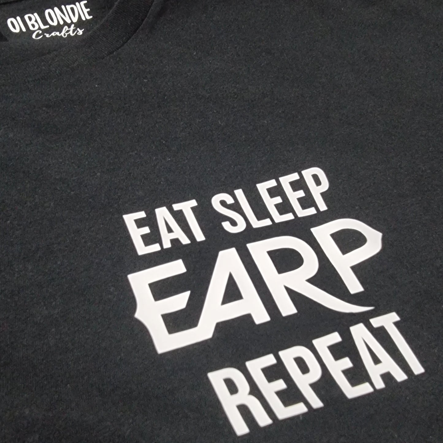 Black t-shirt with white text 'EAT SLEEP EARP REPEAT' on a dark background