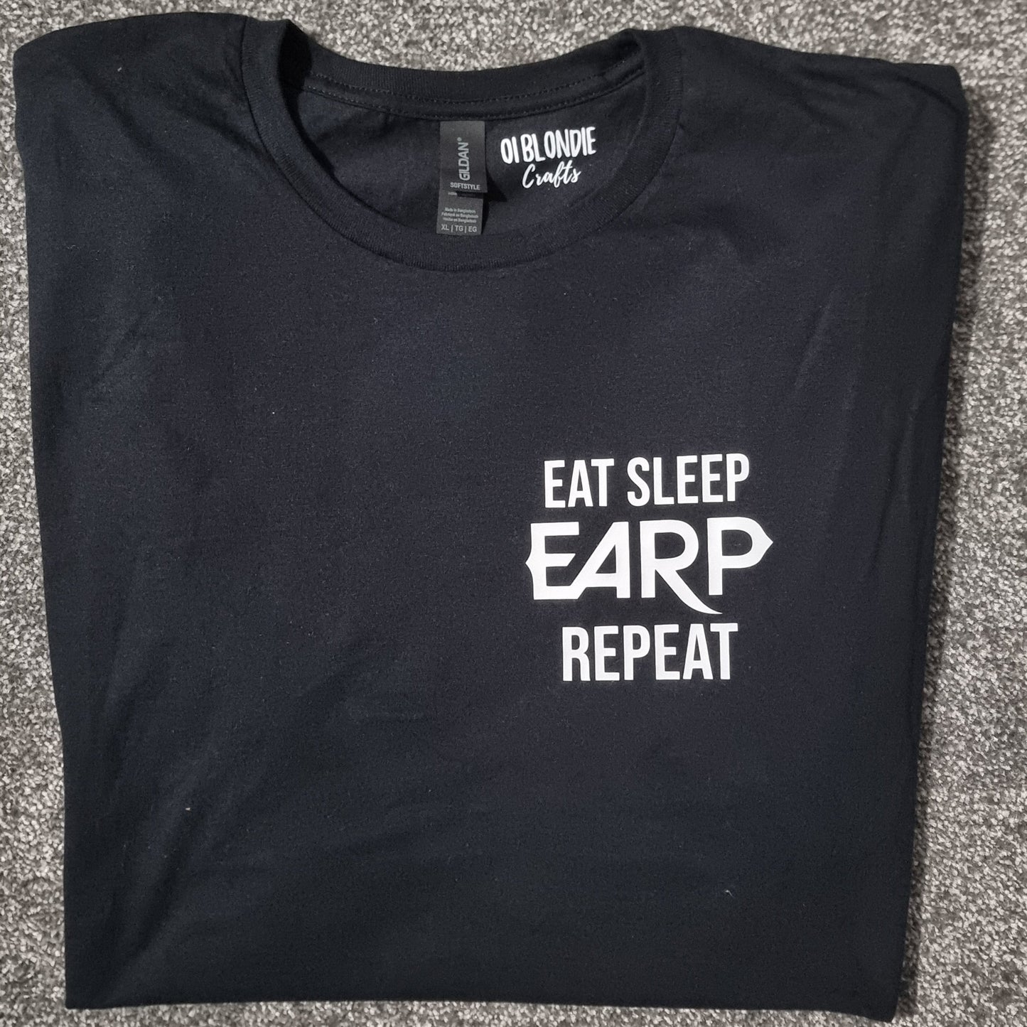 Black t-shirt with 'Eat Sleep EARP Repeat' text on a black surface