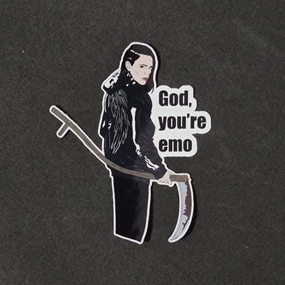 Sticker of Em Cypress and text 'God, you're emo' on a black background