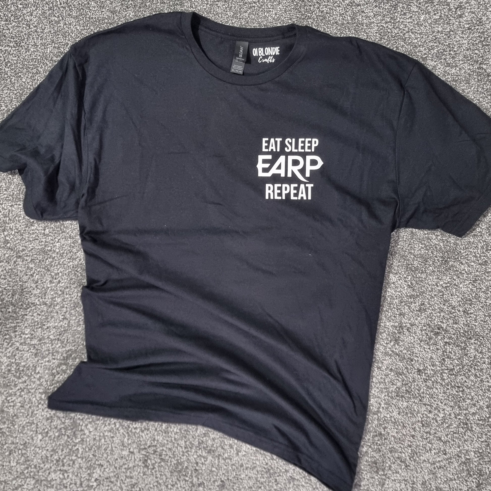 Black t-shirt with 'Eat Sleep EARP Repeat' text on a black surface